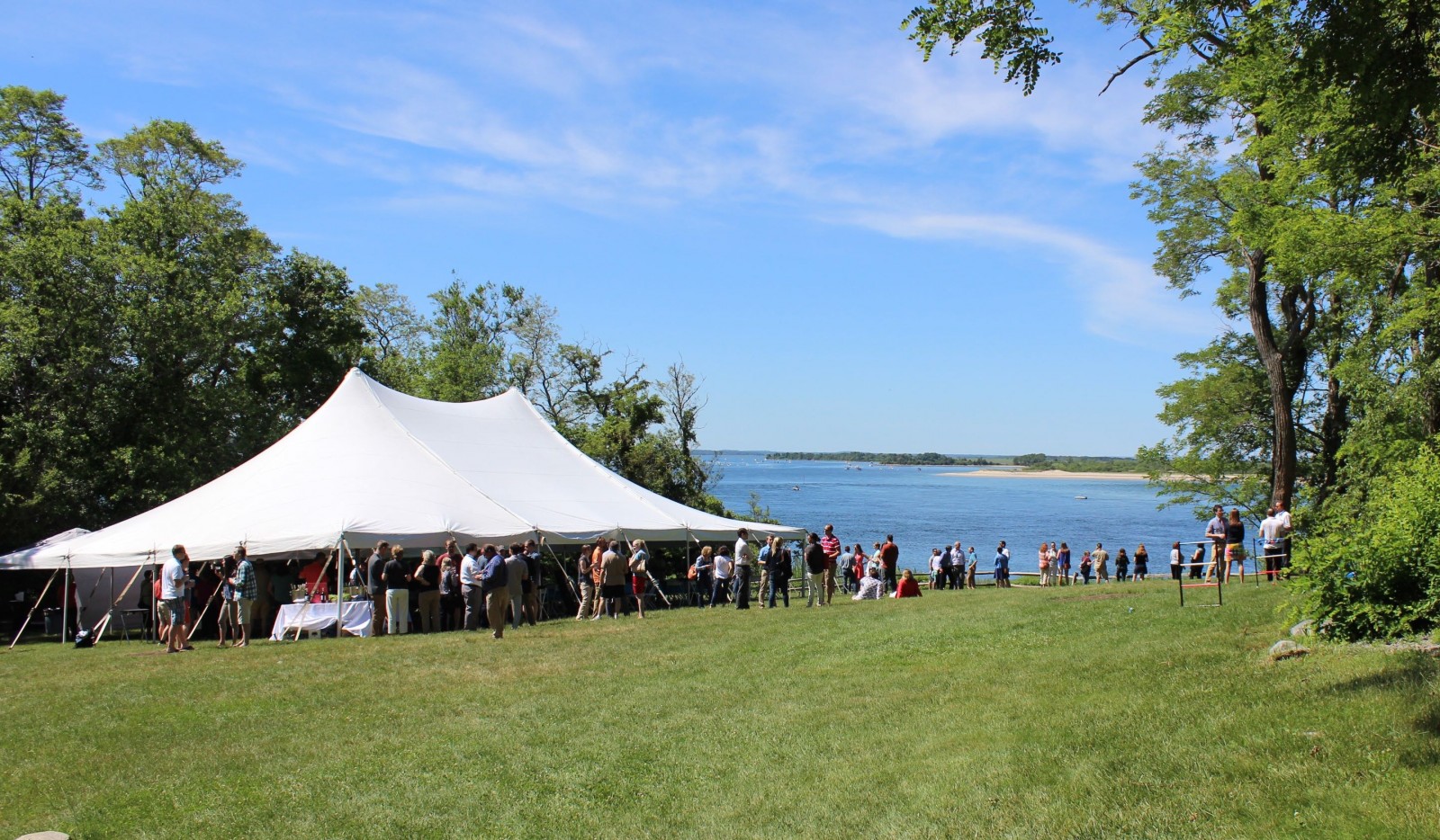 Large event with tent on lawn at Steep Hill Beach overlooking Atlantic ocean