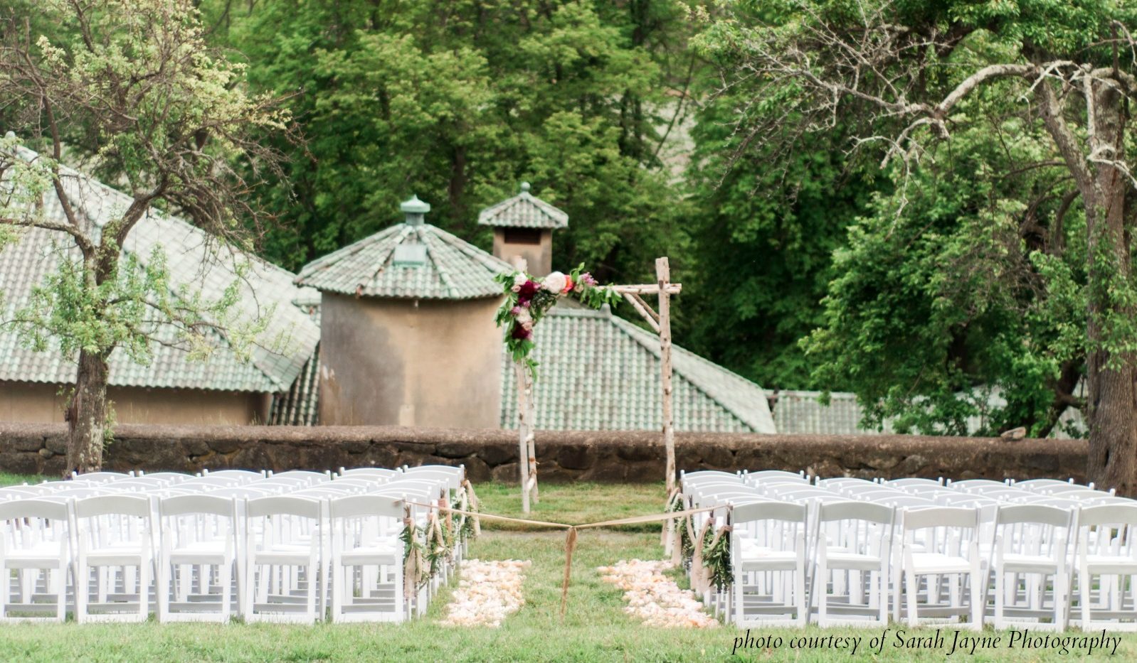 Wedding crermeoy set up on lawn garden overlooking the barn at the crane estate. 