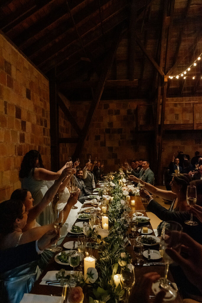 Wedding guests at The Barn at The Crane Estate toast to the newlywed